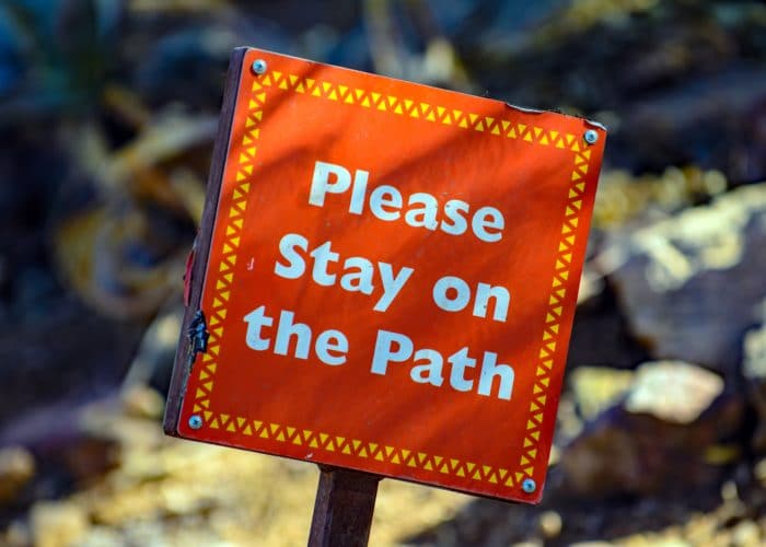 Sign that says please stay on the path