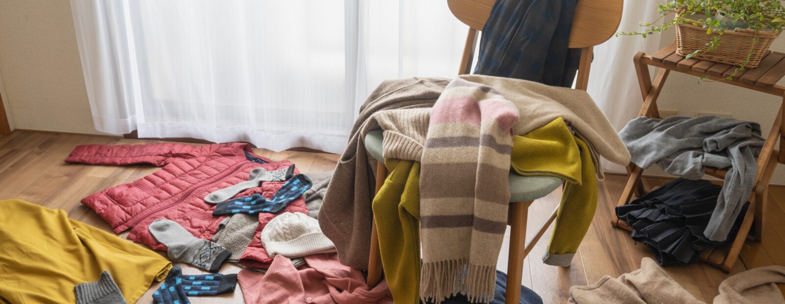 Epämääräinen kasa vaatteita heitettynä lattialle sekä tuolin päälle joka puolelle